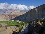 Mustang 03 01 Tetang The trail from Tetang (2940m) climbs through the narrow lanes of the village and then steeply up the valley. I looked back towards the west to see the barley fields of Tetang, the Kali Gandaki valley, and the cake-layered cliffs beyond.